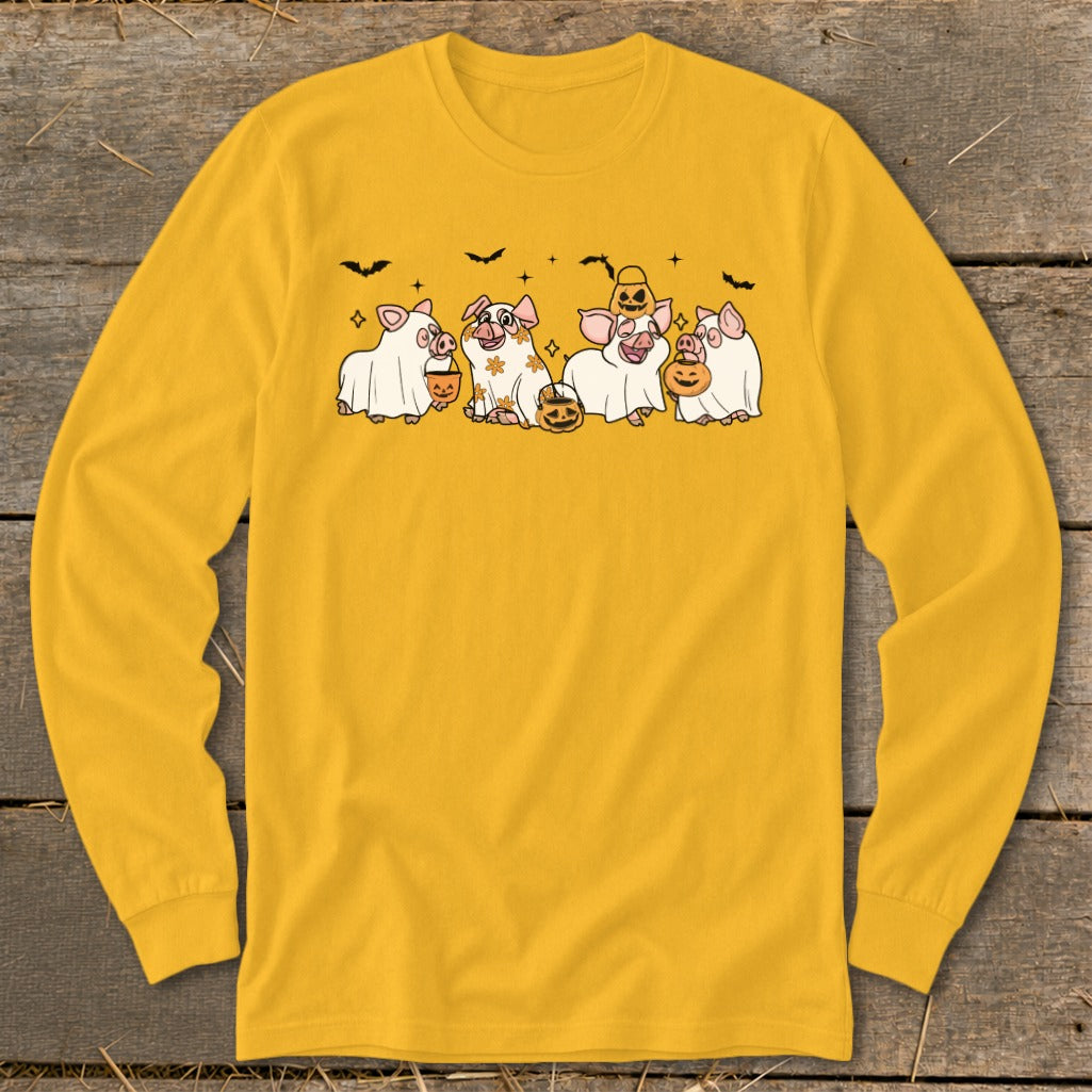 Five cartoon pigs in ghost costumes holding pumpkins on a yellow long-sleeve shirt.