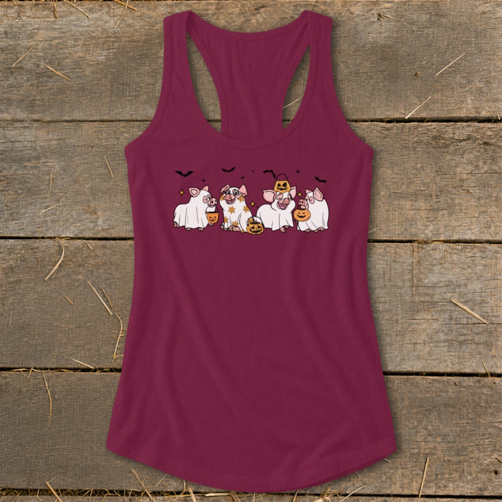 A burgundy tank top with a cartoon of five pigs in Halloween costumes.