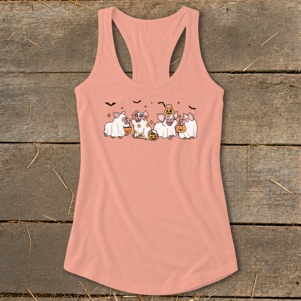 Peach tank top with graphic of pigs in ghost costumes holding pumpkins.