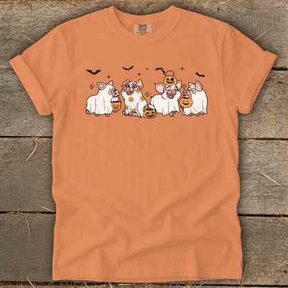 Orange t-shirt with four pigs dressed as ghosts holding pumpkins.