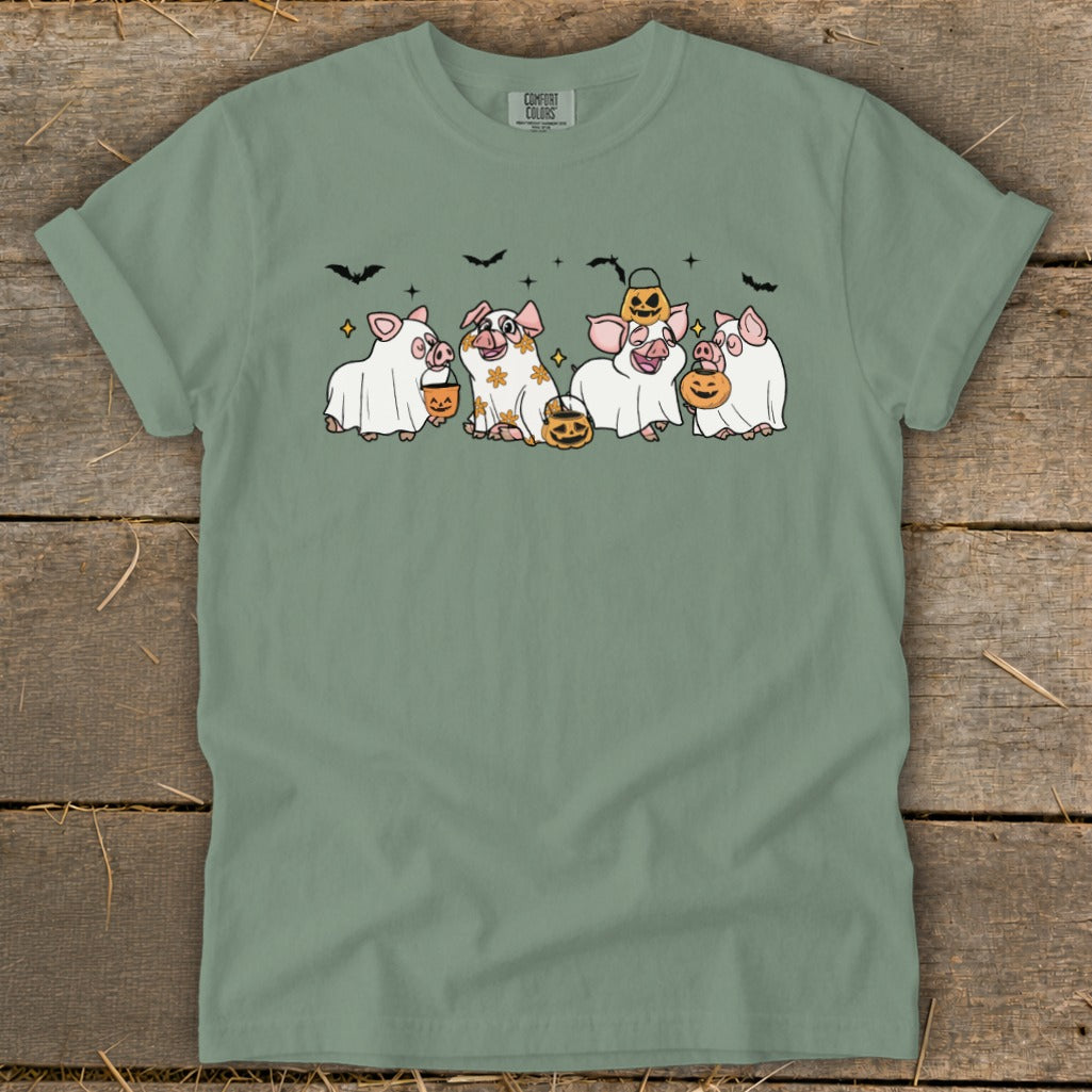 Four pigs in Halloween costumes with pumpkins and bats.