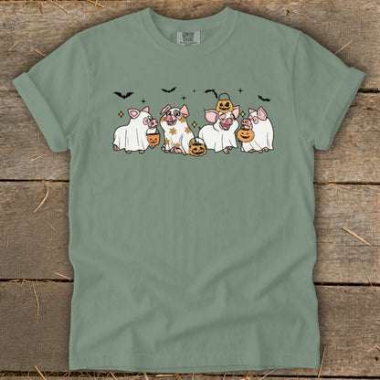Four pigs in Halloween costumes with pumpkins and bats.