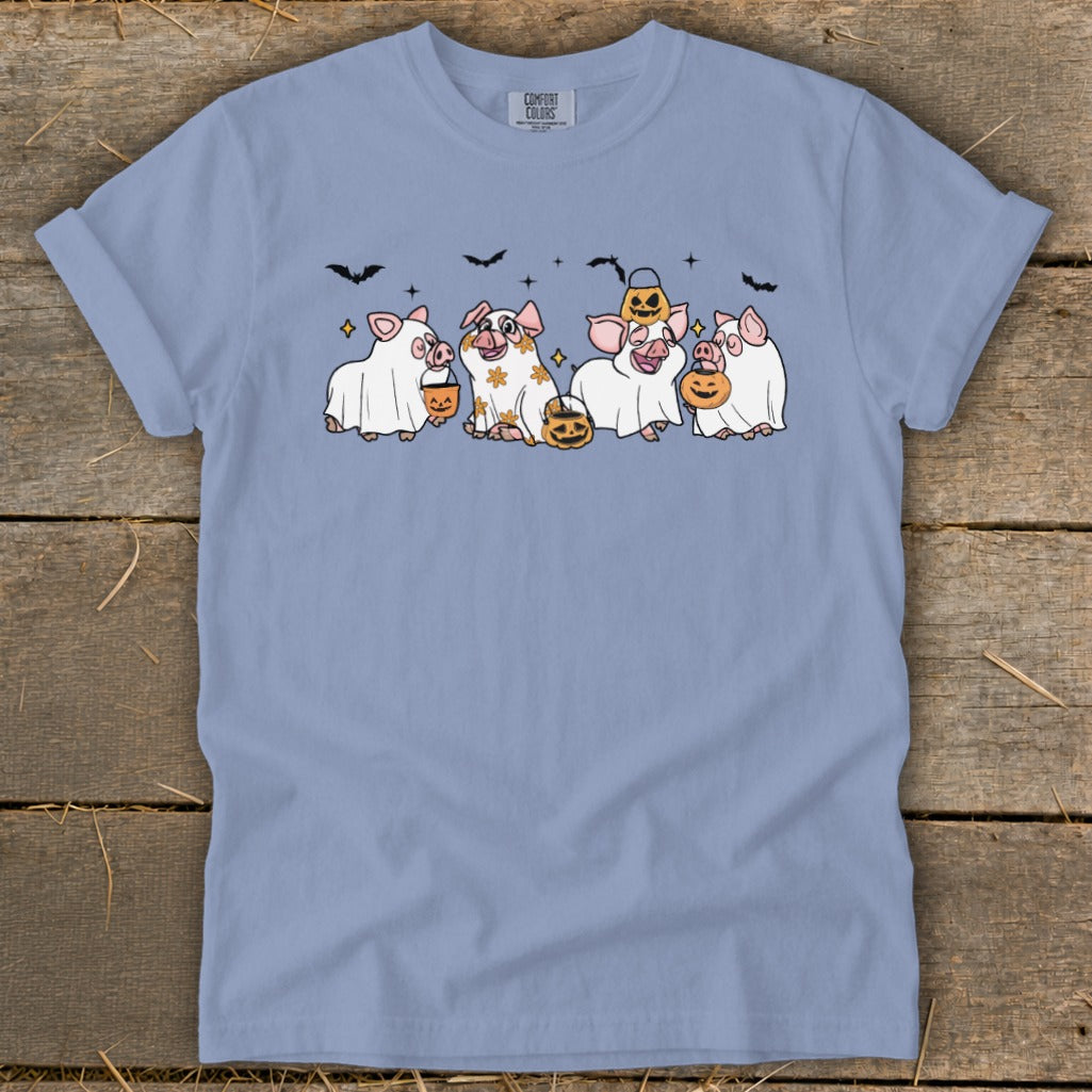 Cute pigs in ghost costumes with pumpkins and bats, Halloween themed graphic.
