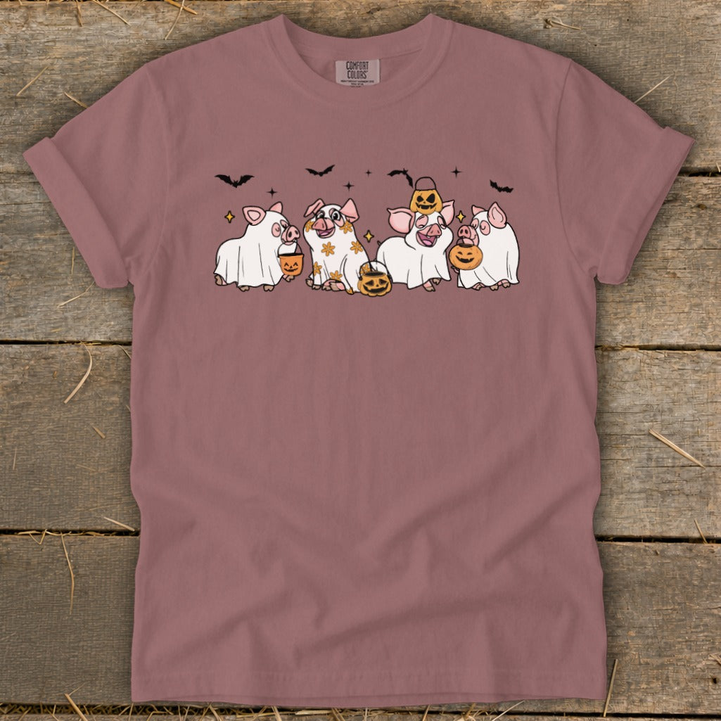 Four pigs in ghost costumes and Halloween pumpkins, with bats and stars above.