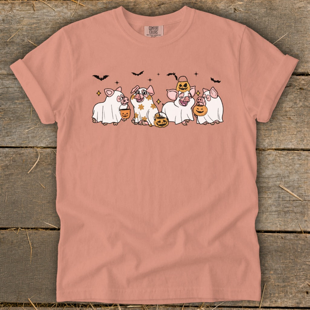 Pigs in ghost costumes holding pumpkins and candy buckets.