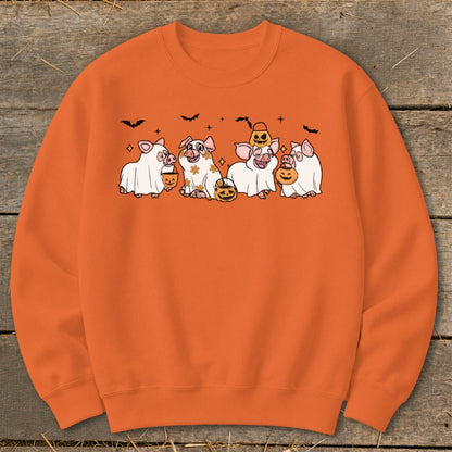 Orange sweatshirt with cartoon pigs dressed as ghosts holding pumpkins and bats.