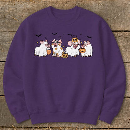 Purple sweatshirt with cartoon pigs in ghost costumes and pumpkins.