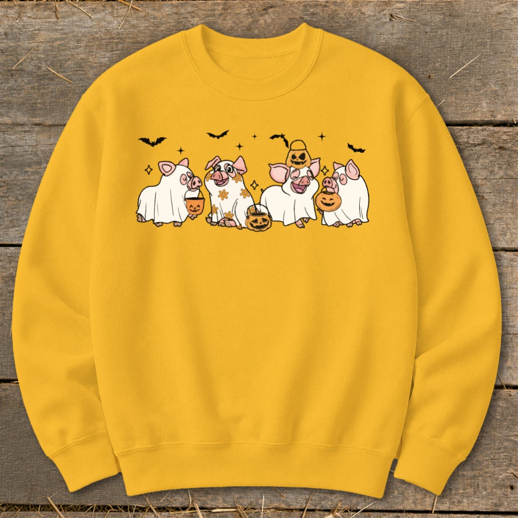 Yellow sweatshirt with five pigs dressed as ghosts for Halloween, holding pumpkins.