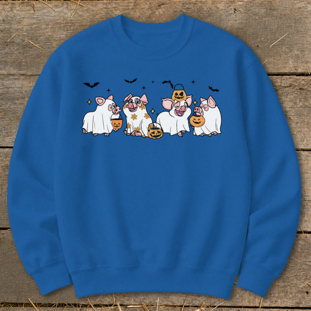 Four cute pigs dressed as ghosts hold pumpkins and candy buckets, with bats overhead.