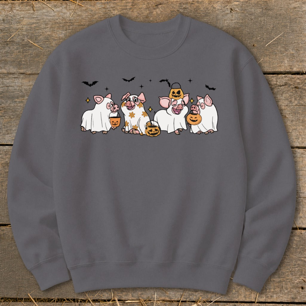 Five pigs in ghost costumes with pumpkins and bats, celebrating Halloween.