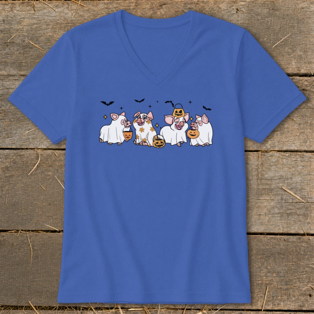 Five pigs dressed as ghosts carry pumpkins and bats on a blue t-shirt.