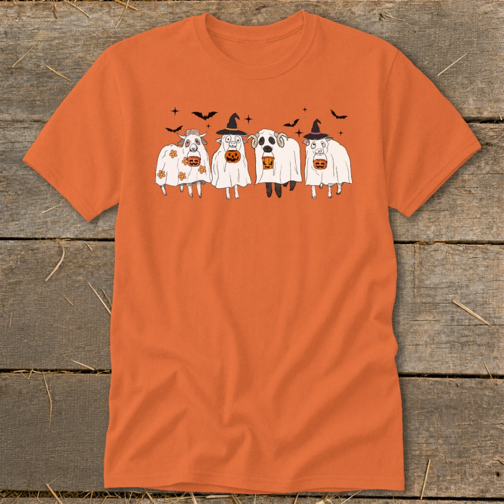 Four sheep dressed as ghosts with pumpkins and witch hats, bats in the background.