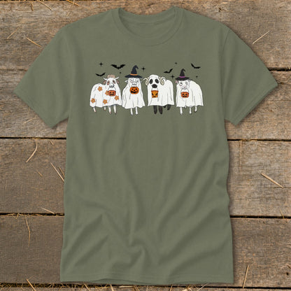 Four sheep dressed as ghosts with pumpkins and witch hats, with bats in the background.