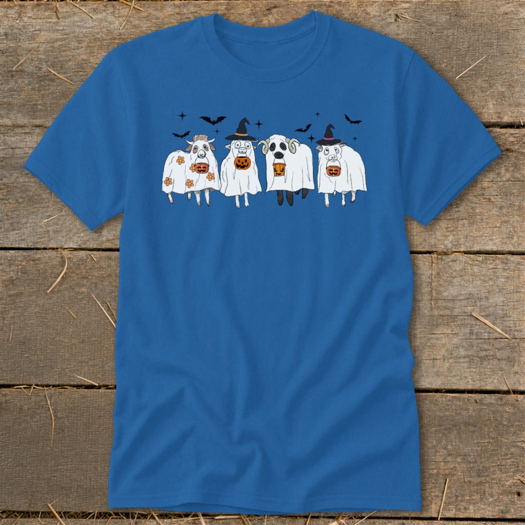 Four cows in ghost costumes with pumpkin buckets and witch hats, bats flying above.