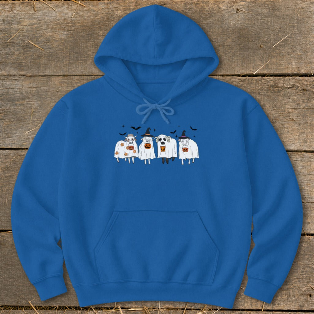 Four cows in ghost costumes with pumpkins and bats on a blue hoodie.