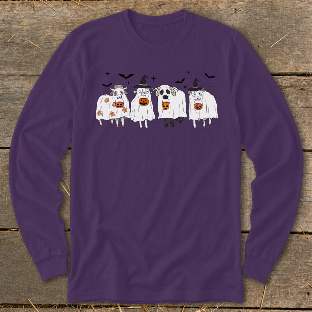 Four sheep in ghost costumes with pumpkin buckets and witch hats celebrate Halloween.