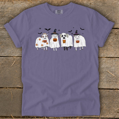 Purple t-shirt with four sheep dressed as ghosts for Halloween, holding pumpkins.