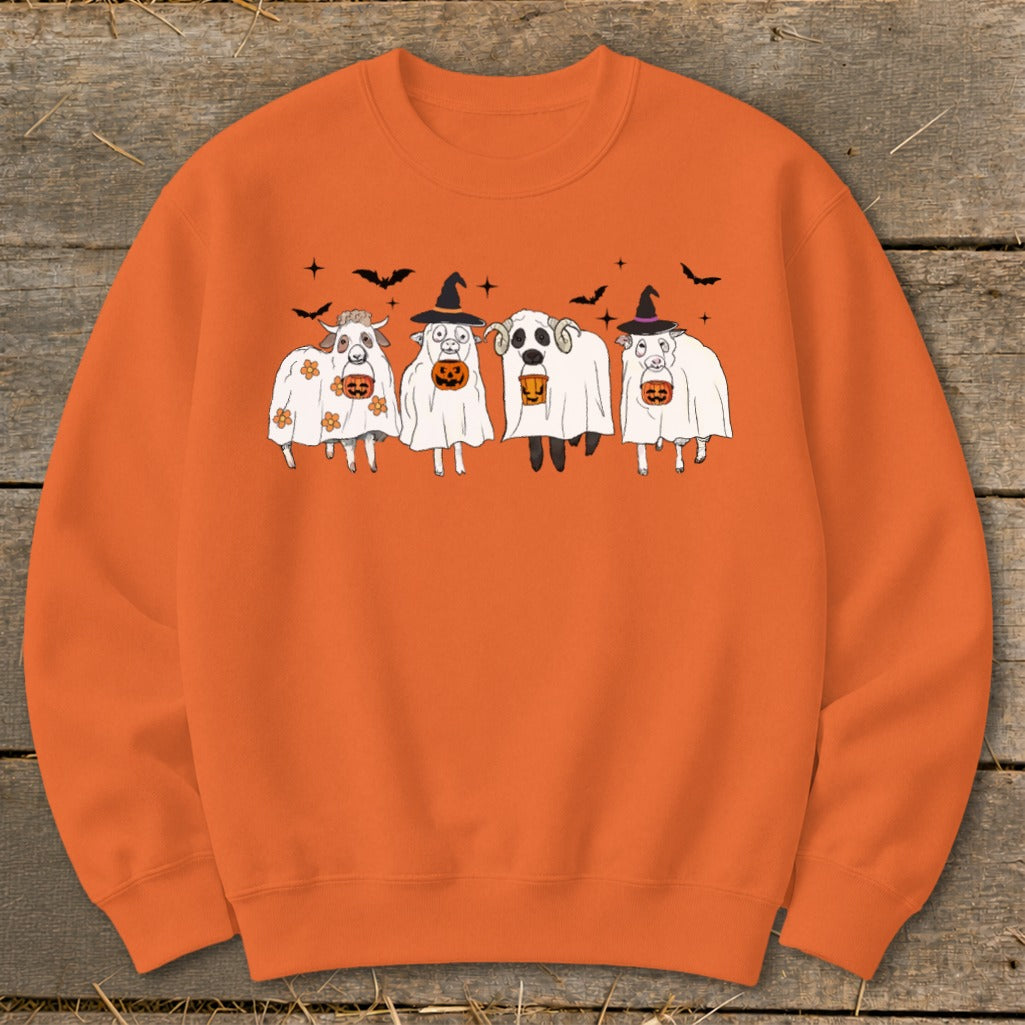 Orange sweatshirt with cartoon sheep in Halloween ghost costumes holding pumpkins.