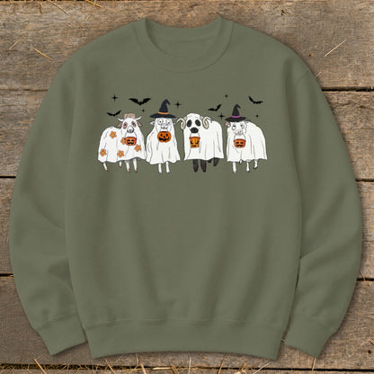 Four sheep in ghost costumes with pumpkins, bats, and witch hats.
