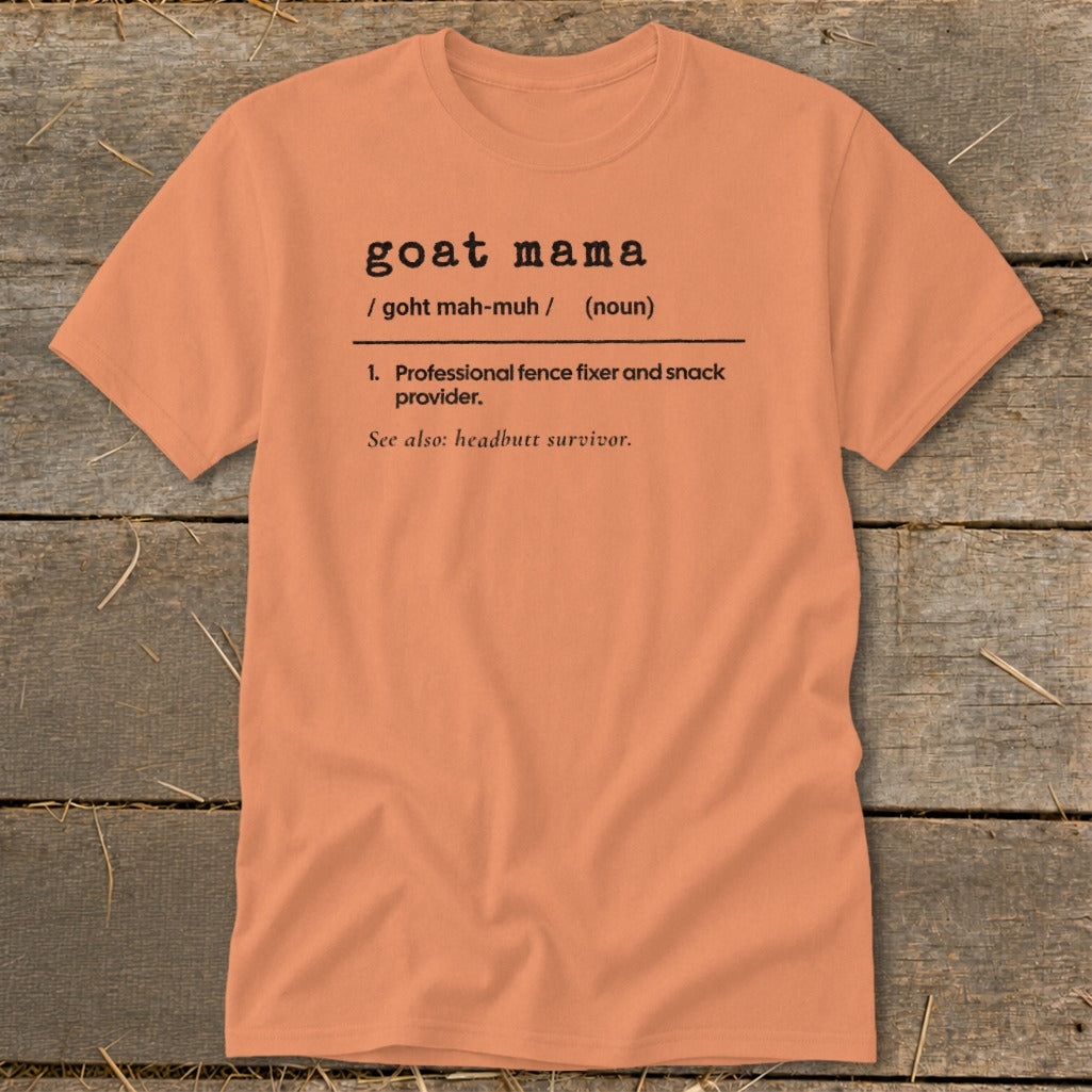 Peach-colored t-shirt with black typewriter-style text reading goat mama definition and professional fence fixer.