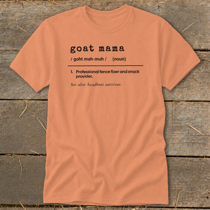 Peach-colored t-shirt with black typewriter-style text reading goat mama definition and professional fence fixer.