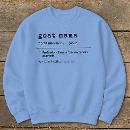 A light blue crewneck sweatshirt featuring black text that defines goat mama as a professional fence fixer and snack provider.