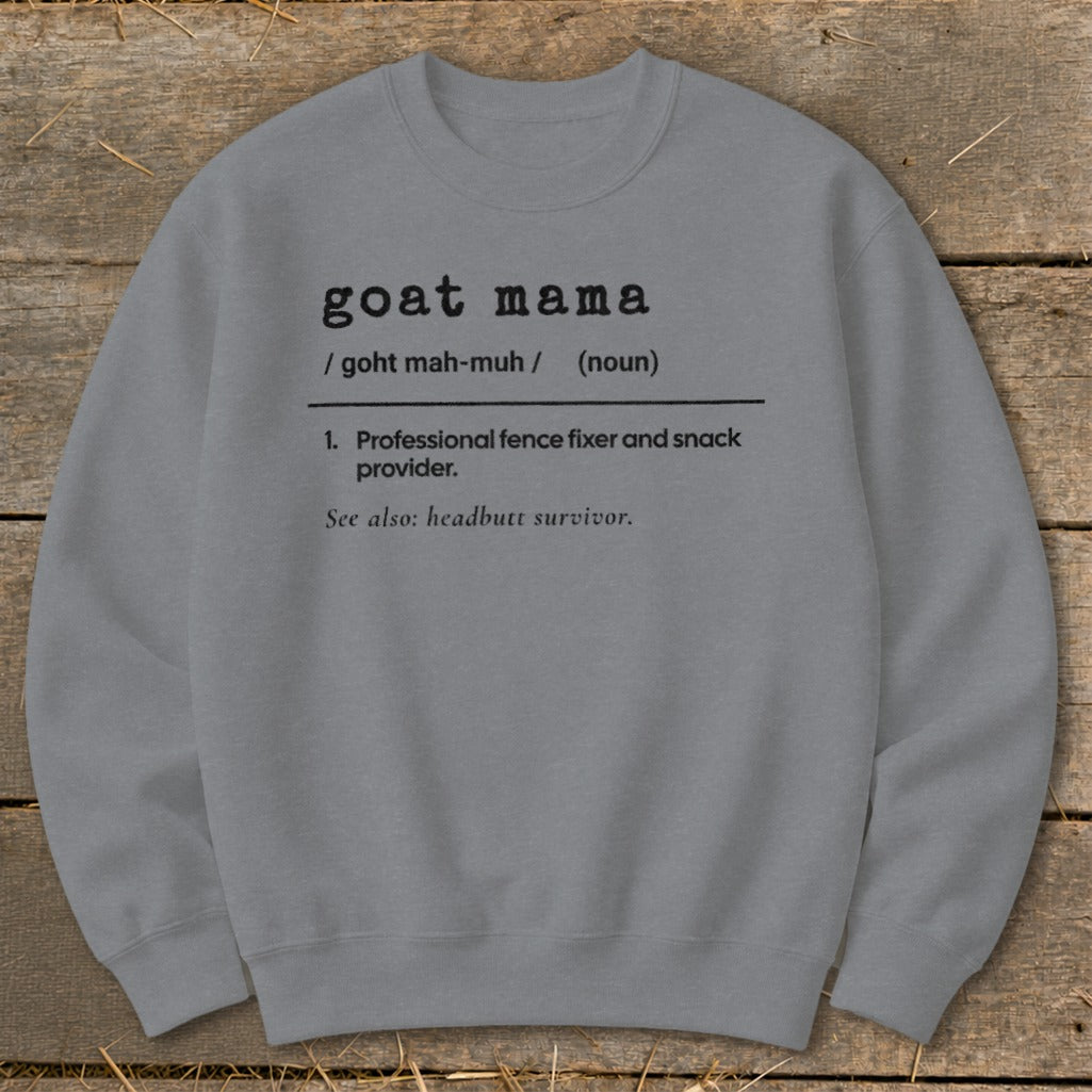 A grey crewneck sweatshirt printed with a dictionary definition graphic that reads goat mama.