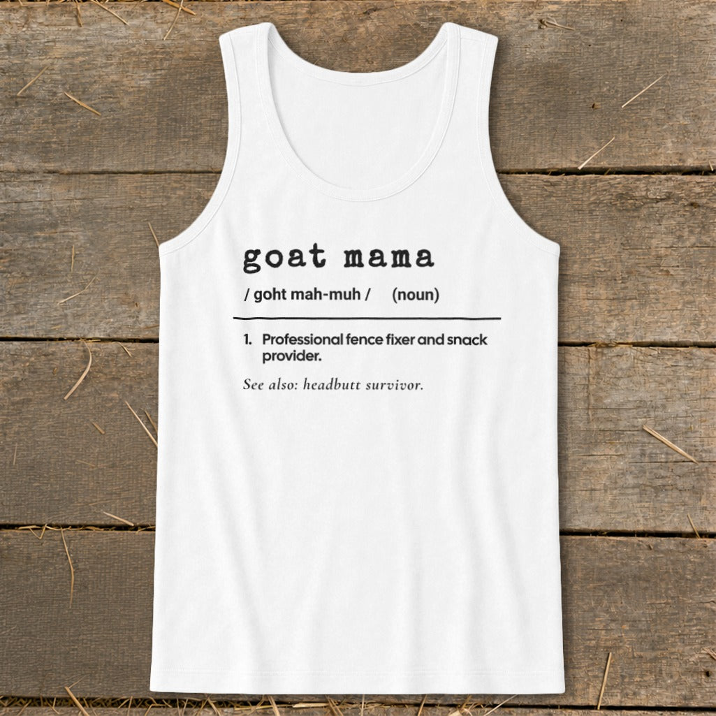 A white tank top printed with a dictionary definition for "goat mama" laid on a wooden background.