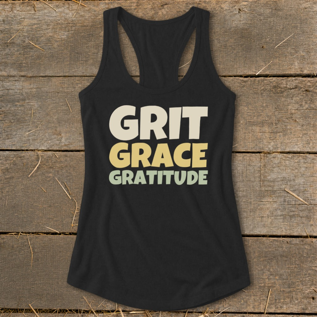 Black racerback tank top with the words GRIT GRACE GRATITUDE printed on the front in cream, yellow, and green.