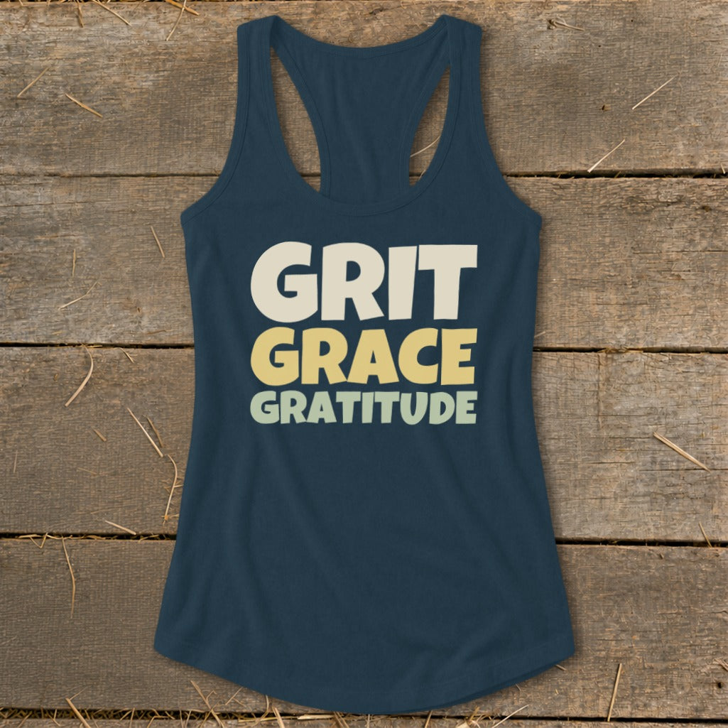 Navy blue racerback tank top with the words Grit, Grace, Gratitude printed in stacked lettering.