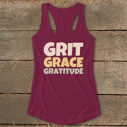 Maroon racerback tank top with the words Grit, Grace, and Gratitude printed across the chest.