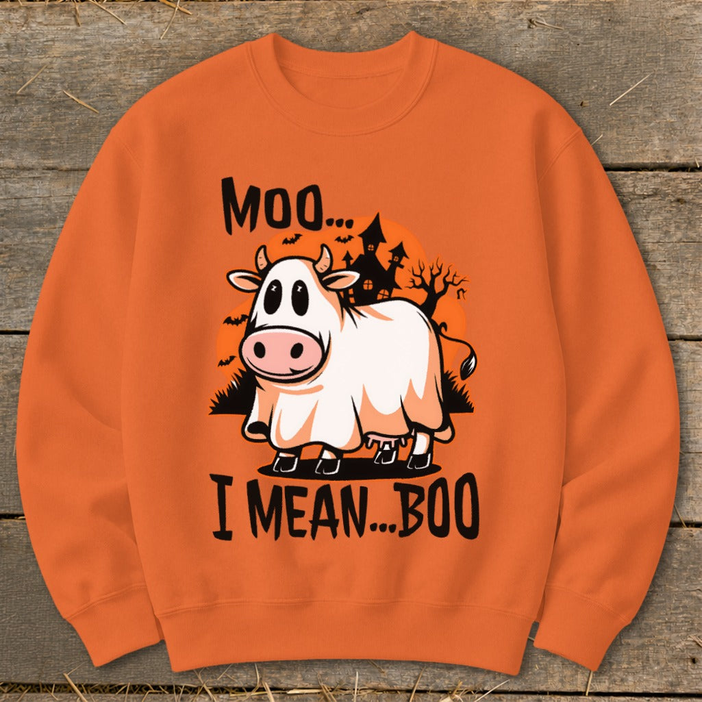 Orange sweatshirt with a cow in a ghost costume and Halloween castle graphic.
