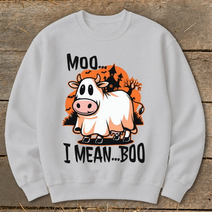 Cow in a ghost costume saying "Moo... I mean... Boo" with haunted houses.