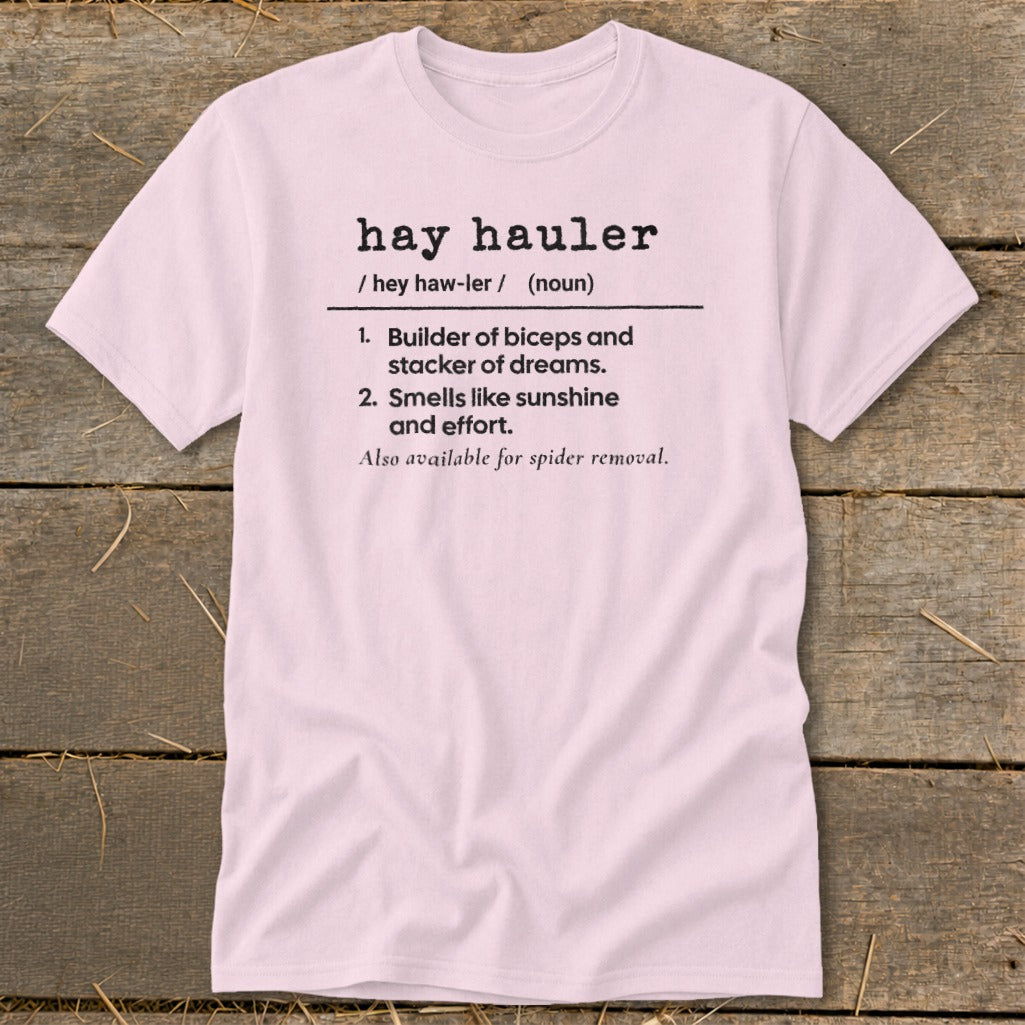 Pink t-shirt with "hay hauler" definition: Builder of biceps, stacker of dreams, smells like sunshine.