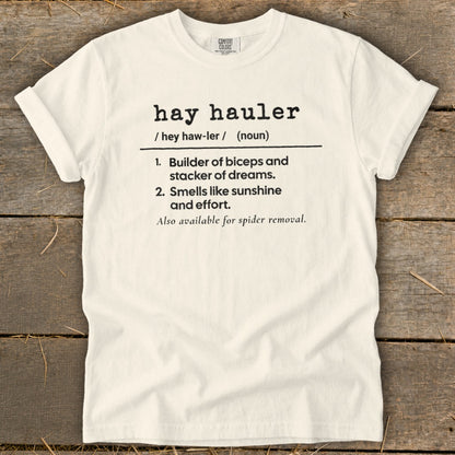 White t-shirt with black text defining "hay hauler".