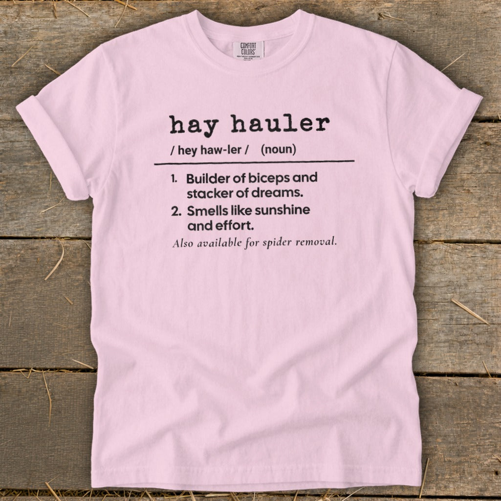 Pink t-shirt with black text defining "hay hauler" and its characteristics.