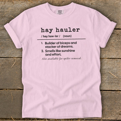 Pink t-shirt with black text defining "hay hauler" and its characteristics.