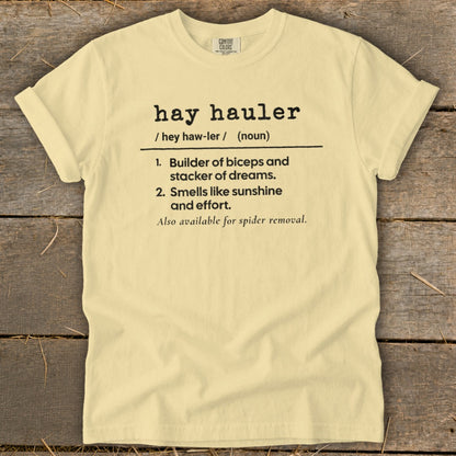 Light yellow t-shirt with "hay hauler" definition and spider removal joke.