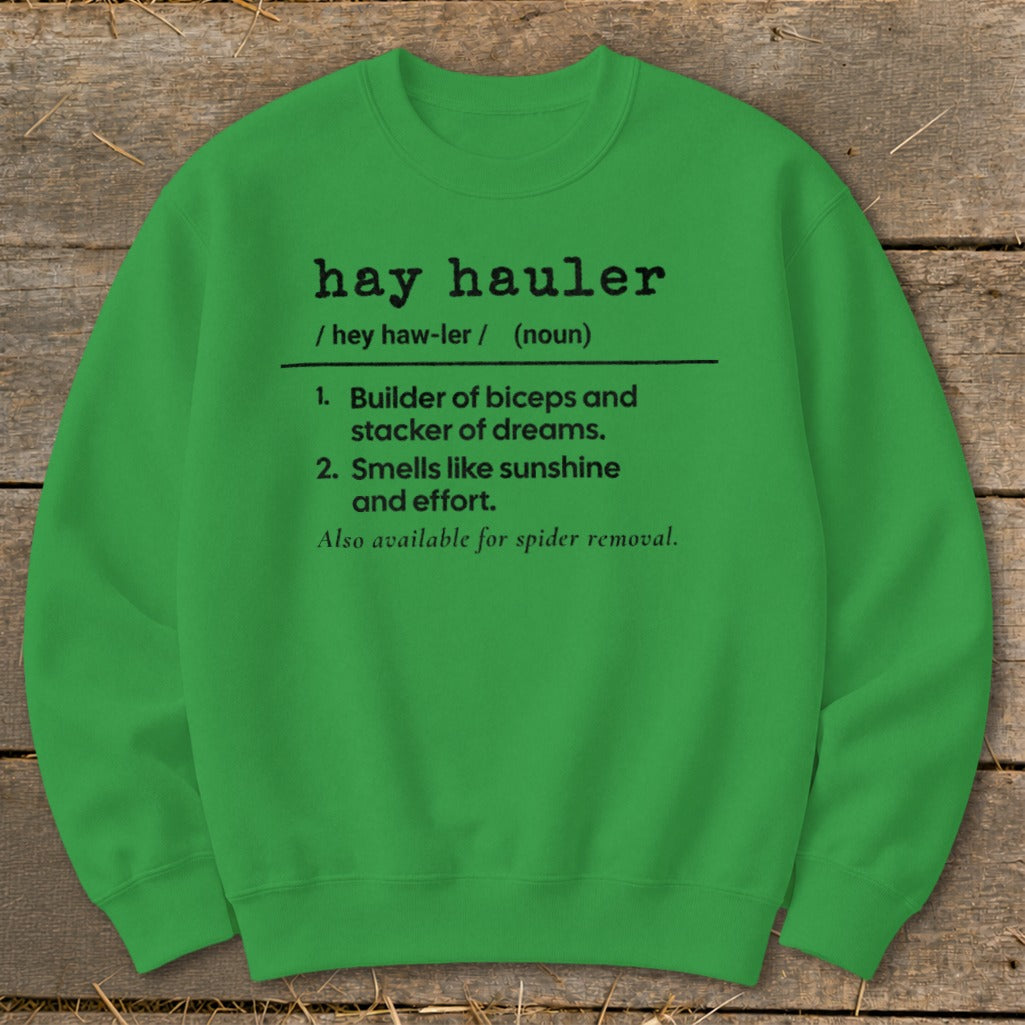 Green sweatshirt with "hay hauler" definition: builder of biceps, dreams, and spider removal.