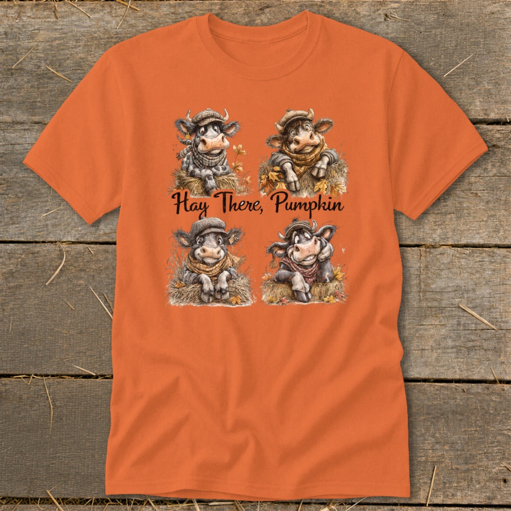 Orange t-shirt with four cartoon cows and "Hay There, Pumpkin" text.