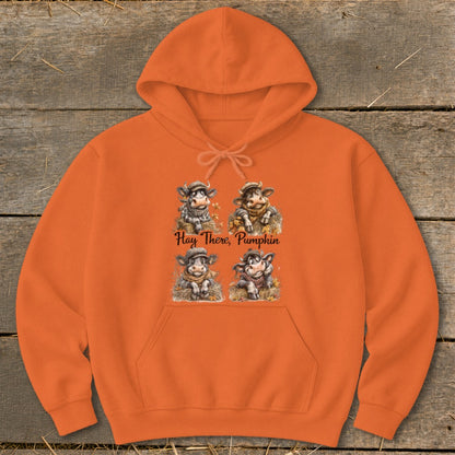 Orange hoodie with four cartoon cows and "Hay There, Pumpkin" text.