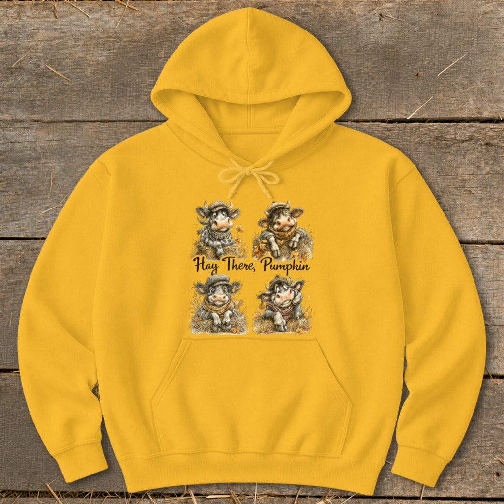 Yellow hoodie with four cartoon cows and text "Hay There, Pumpkin".