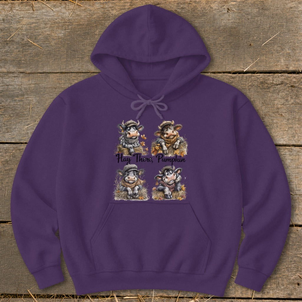 Purple hoodie with four cartoon cows and the text "Hay There, Pumpkin".
