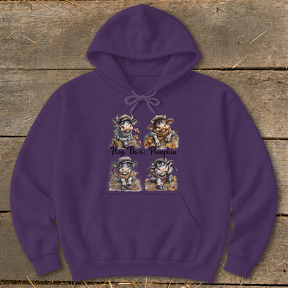 Purple hoodie with four cartoon cows and the text "Hay There, Pumpkin".