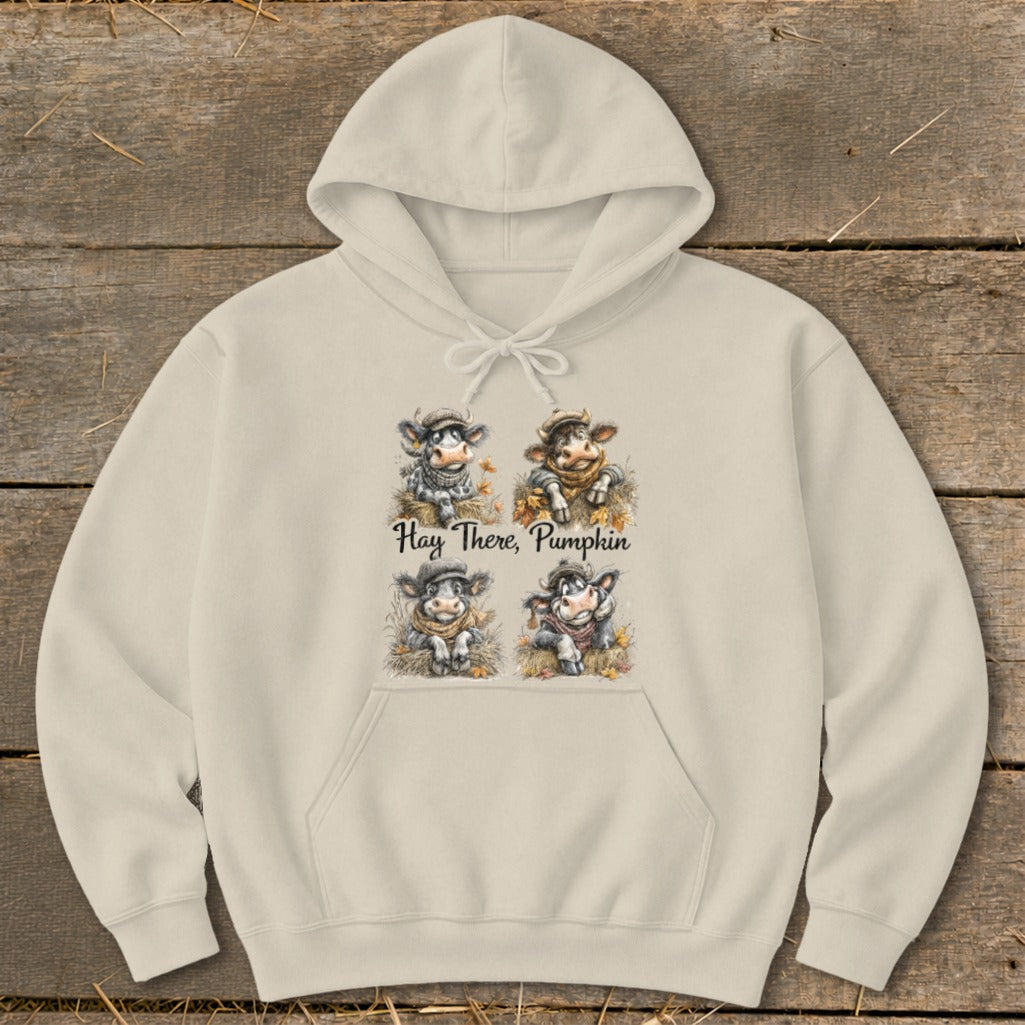 Beige hoodie with four cartoon cows and the text "Hay There, Pumpkin".