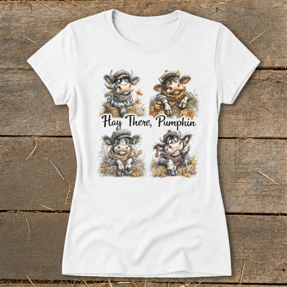 White t-shirt featuring four cartoon cows with hats and scarves, text "Hay There, Pumpkin".