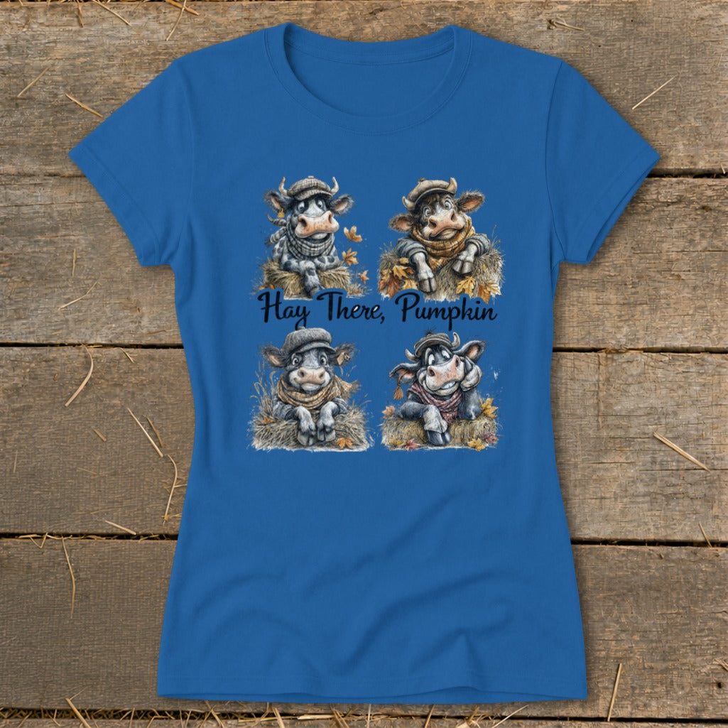 Blue t-shirt with four cartoon cows wearing hats and scarves, with text "Hay There, Pumpkin".