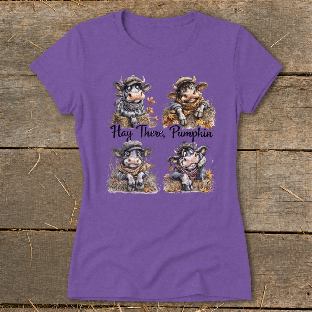 Purple t-shirt with four cartoon cows in hats and scarves, text "Hay There, Pumpkin".