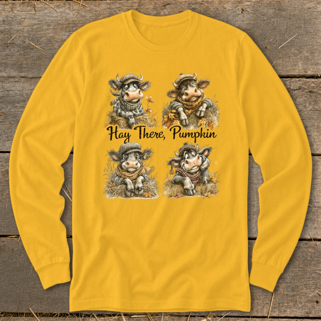 Yellow long-sleeve shirt with four cartoon cows and "Hay There, Pumpkin" text.
