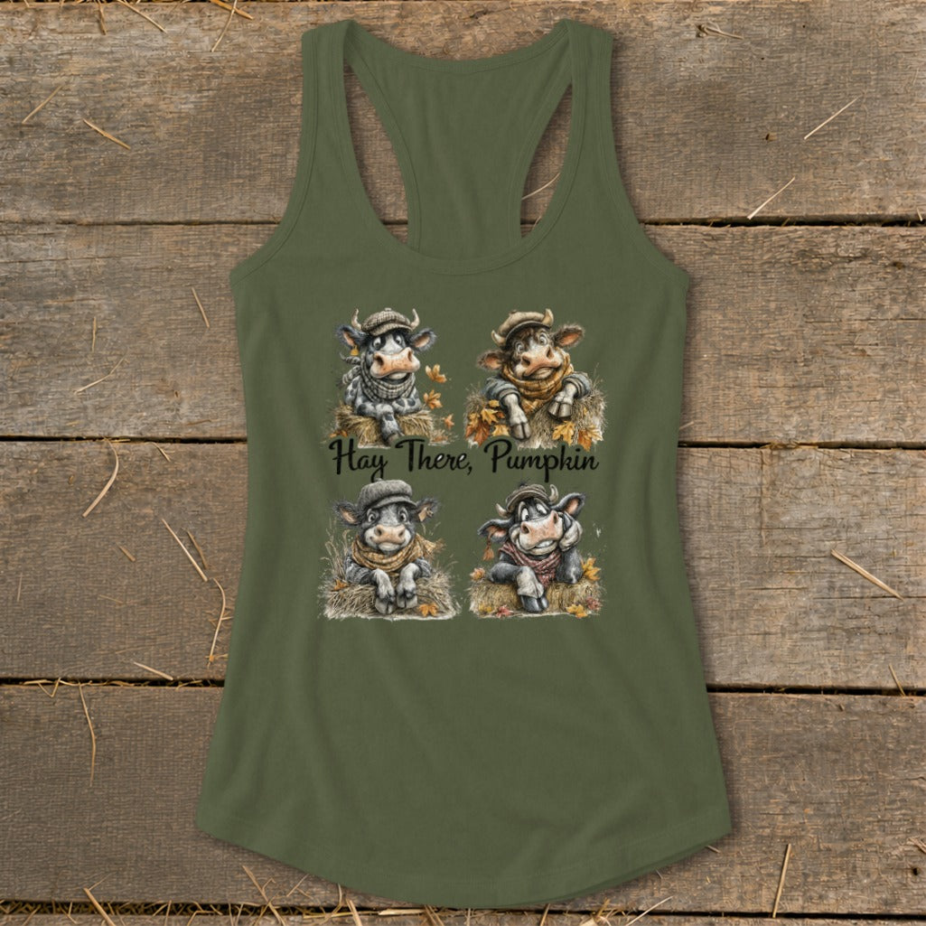 Four cartoon cows wearing scarves and hats on a tank top, with text "Hay There, Pumpkin".